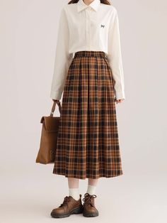 Pleated plaid midi skirt in cozy colors to go with your autumnal fits. Features an elastic waist back. Lined. One Size: 26"-36" waist, 31" length Fall Pleated Skirt With Elastic Waistband, Relaxed Fit, Plaid Midi Skirt For Fall, Fall Long Pleated Skirt With Elastic Waistband, Plaid Midi Skirt Casual Style, Casual Plaid Midi Skirt, Casual Pleated Skirt With Elastic Waistband For Fall, Fall Midi Skirt With Elastic Waistband, Casual Brown Pleated Midi Skirt, Casual Pleated Plaid Skirt