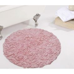 a bathroom rug with pink roses on it