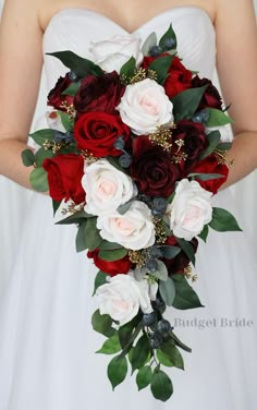 a bride holding a bouquet of red and white flowers