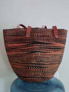 "Black and orange sisal tote bag DIMENSIONS Bottom width: 10\"/25.5cm Top width: 14\"/35.56cm Depth: 10\"/25.5cm Straps: 15\"/38cm SHIPPING All orders ship via DHL Express (3-5) days delivery time." Black Bucket Straw Bag With Handles, Black Large Capacity Shoulder Bag For Market, Traditional Black Tote Shoulder Bag, Traditional Black Tote Bag, Black Bags For Market, Large Capacity Black Bag For Market, Traditional Black Bag For Everyday Use, Black Bucket Bag With Leather Handles For Market, Black Shoulder Bag For Market With Handles