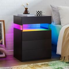 a black night stand with multicolored drawers