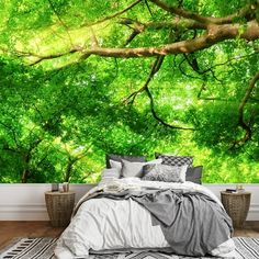 a bedroom with green trees on the wall