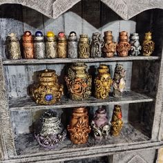 there are many different vases on the shelves