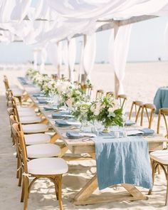 a long table is set up on the beach