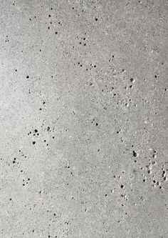 the texture of concrete is white and gray with black dots on it, as well as small holes in the cement