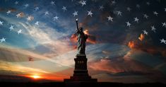 the statue of liberty is silhouetted against an american flag in this artistic photo taken at sunset