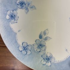 a blue and white plate with flowers on it