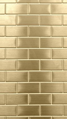 a close up view of a gold brick wall