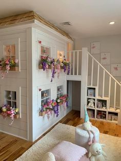 a doll house is decorated with flowers and stuffed animals