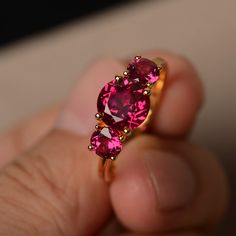 This is a gorgeous handmade creation. Its beauty is its simplicity & Elegance. The 8*8 mm round cut ruby(about 2.60 ct) is crafted in solid sterling silver or 14k white/rose/yellow gold All item is sent in a beautiful gift box If you have any idea of design your ring,pls contact me directly. You can realize more lovely stuff clicking the link https://www.etsy.com/shop/knightjewelry?refshopsection_shophome_leftnav Please leave the correct address and you phone number for delivering successful Formal Ruby Birthstone Ring, Formal Ruby Cluster Ring, Brilliant Round Cut Lab-created Ruby Jewelry, Fine Jewelry With Round Lab-created Ruby, Garnet Rings With Accent Stones, Red Brilliant Cut Pink Sapphire Jewelry, Red Pink Sapphire Jewelry With Brilliant Cut, Red Solitaire Sapphire Ring, Red Round Solitaire Sapphire Ring