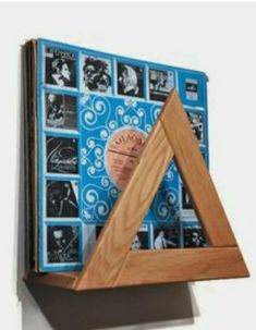 a wooden frame with pictures on it and a plaque in the shape of a triangle