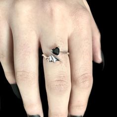 Sterling silver ring of a bat wing with a black crystal heart. Each ring is hand cast in sterling silver. Comes in size 7 but can be slightly adjusted to be smaller or larger. This ring can also be taken to be resized by a jeweler if needed. Goth Engagement, Goth Engagement Rings, Future Jewelry, Vampire Wedding, Bat Ring, Wing Ring, Obsidian Stone, Pagan Witchcraft, Goth Jewelry