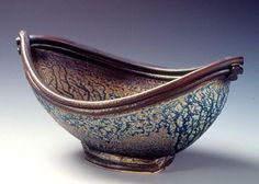 a blue and brown bowl with writing on it