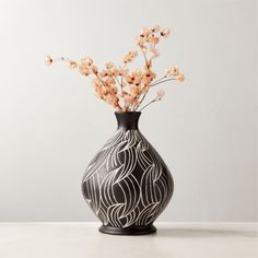 a black and white vase with flowers in it