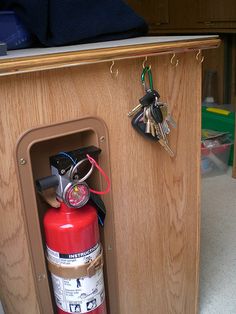 an open fire extinguisher with keys in it