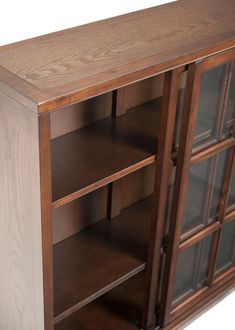 a wooden cabinet with glass doors and shelves