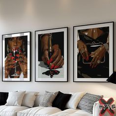 three framed pictures hang on the wall above a white couch in a living room with black and white decor