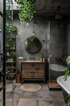 a bathroom with a sink, mirror and plants hanging from the ceiling over it's bathtub