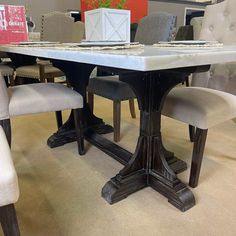 a dining table with chairs around it and a box on the table next to it