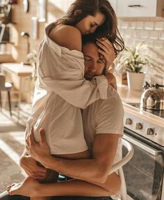 a man hugging a woman in the kitchen