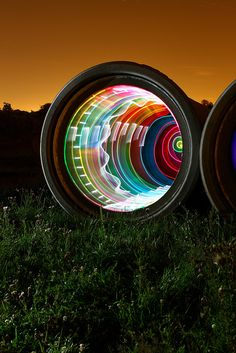 two circular lights in the grass at night