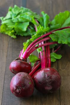 some beets are laying on a wooden table