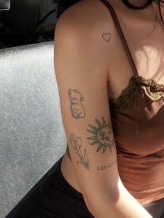 a woman with tattoos on her arm holding a cell phone