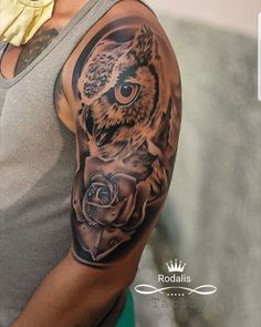 an owl and rose tattoo on the left upper half of his arm is shown in black and grey