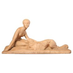 a sculpture of a man laying on the ground next to a woman's body