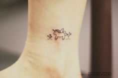 a small horse tattoo on the ankle