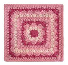 a crocheted square with pink and white squares on it, in the shape of a flower