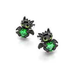 pair of black cat earrings with green crystal eyes and tail, on white back ground