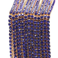 blue and gold beaded bracelet on a white background with clipping for the clasp