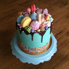 there is a blue cake with lots of candies on it