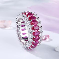 a ring with pink and white stones on it