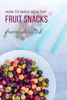 a white bowl filled with fruit snacks on top of a table