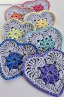 several crocheted hearts are arranged on a table