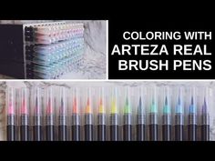 there are many different colored pens in the holder on the wall and behind them is a black box with white writing that says, coloring with artza real brush pens