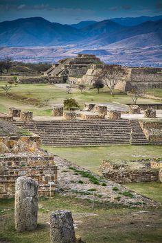 an ancient city in the middle of nowhere with mountains in the backgrouds