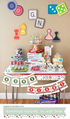 a table topped with lots of candy and candies next to a wall covered in magnets