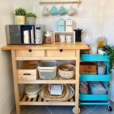 a kitchen island with plates, bowls and cups on the top is next to a coffee maker