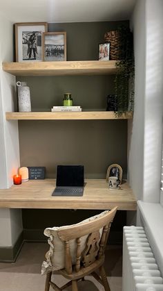 a wooden chair sitting in front of a desk with a laptop computer on top of it