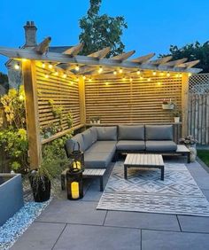 an outdoor living area is lit up with string lights