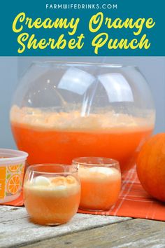 orange sherbet punch in front of an orange pitcher and two glasses filled with liquid