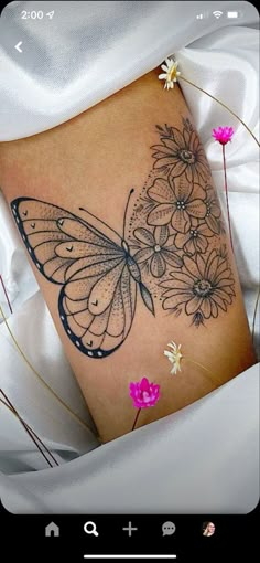 a woman's stomach with flowers and a butterfly on it