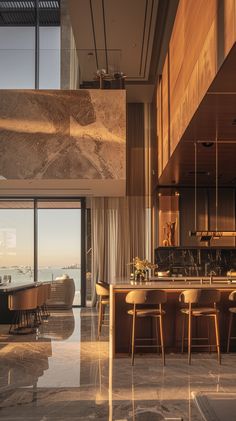 a large kitchen and dining area with marble flooring next to an open window overlooking the ocean