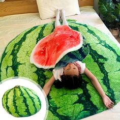 a woman laying on top of a bed covered in watermelon