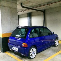 a blue car parked in a parking garage