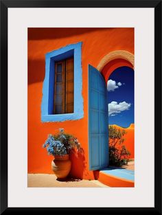 an orange and blue house with a potted plant next to the door that is open