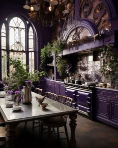 the dining room table is surrounded by purple cabinetry and potted plants in vases